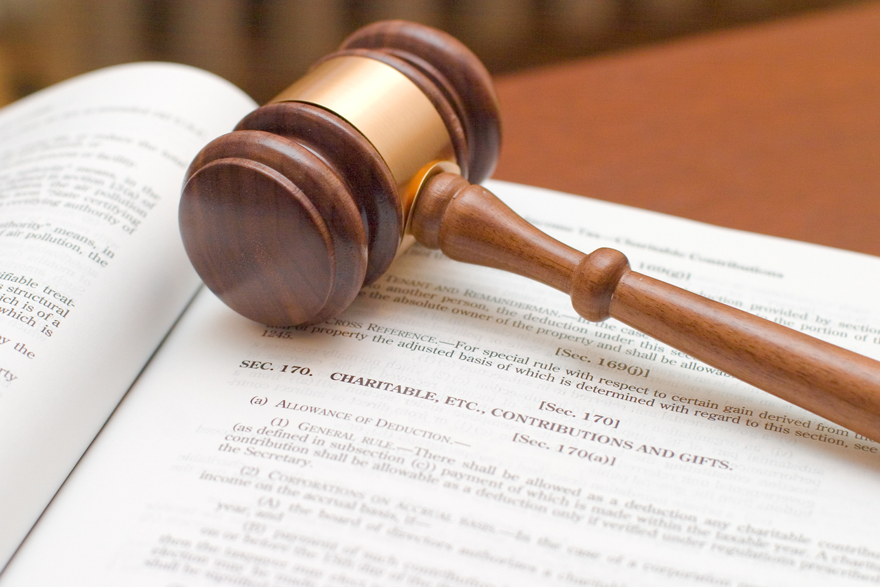 Tax law concept: gavel over Internal Revenue Code section dealing with deductability of charitable contributions.