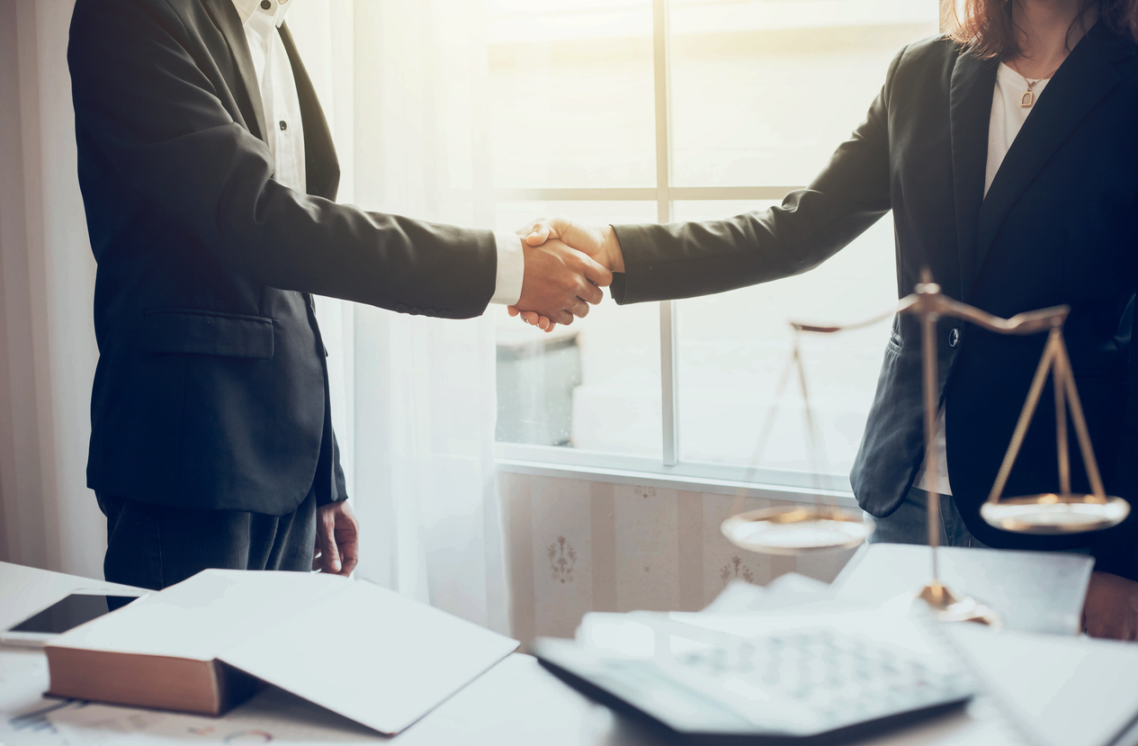 Businessman and lawyer shaking hands.