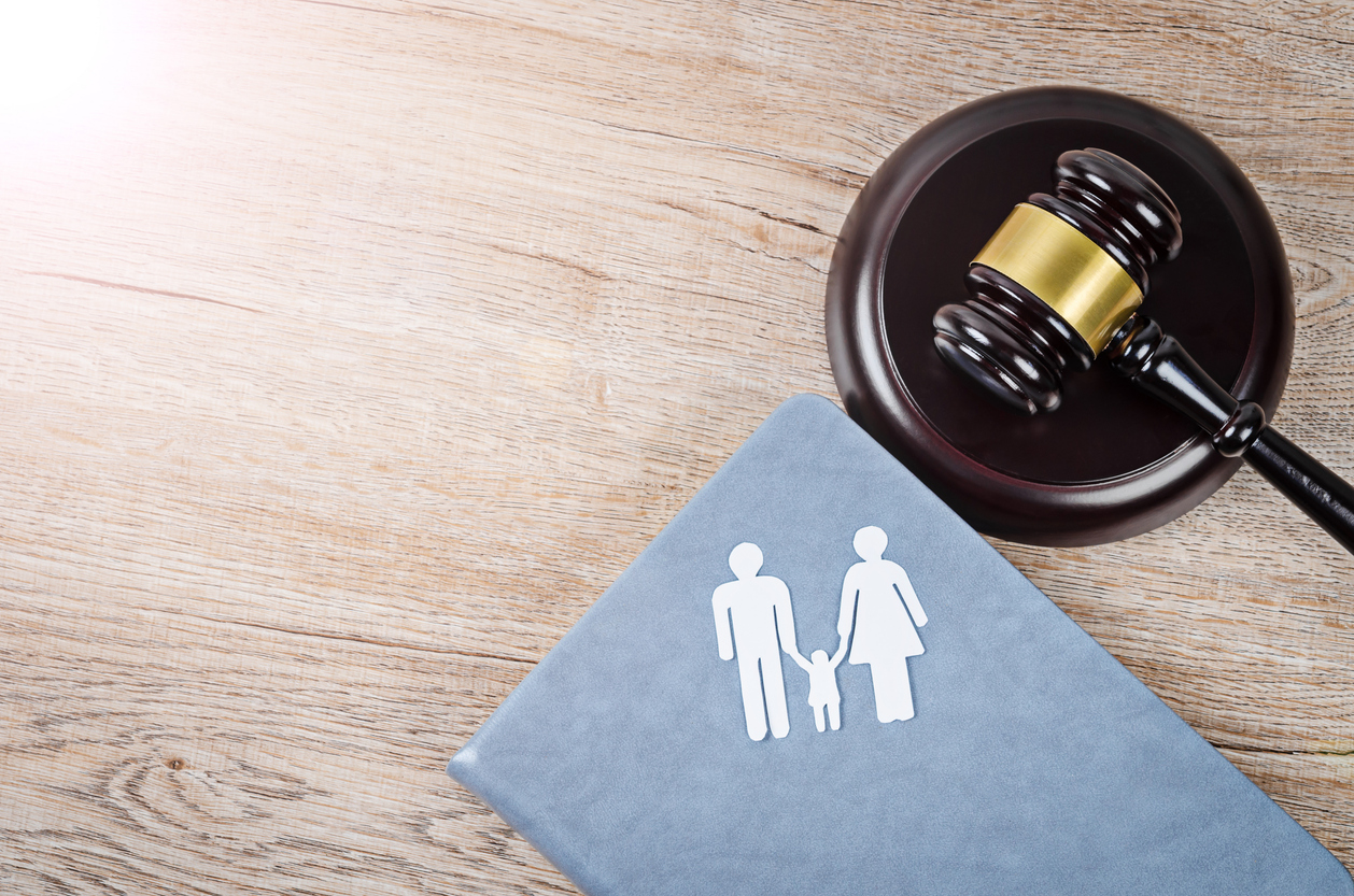 Family figure and gavel on table. Family law concept