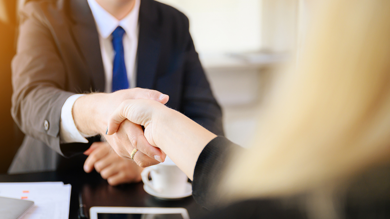 Businessman and woman shake hands as hello in office closeup. Friend welcome, introduction, greet or thanks gesture, product advertisement, partnership approval, arm, strike a bargain on deal concept