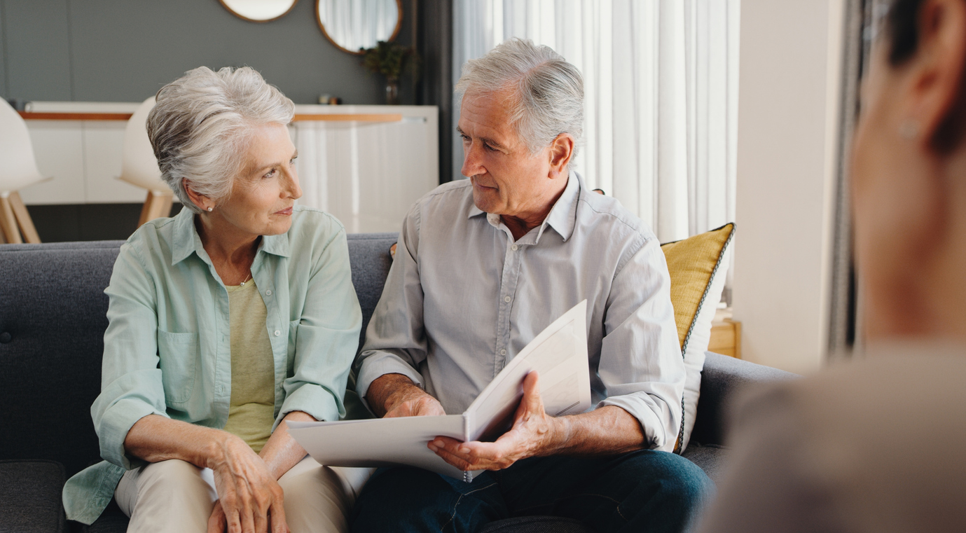 Senior and retired couple talking with finance documents in meeting with lawyer, planning retirement and will paperwork together in home. Mature man and woman in discussion about pension with advisor