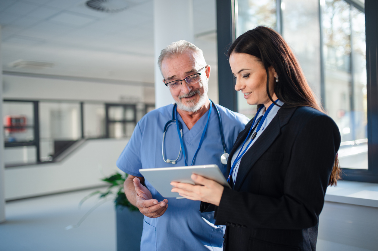 Young lawyer explaining something to doctor in a hospital.