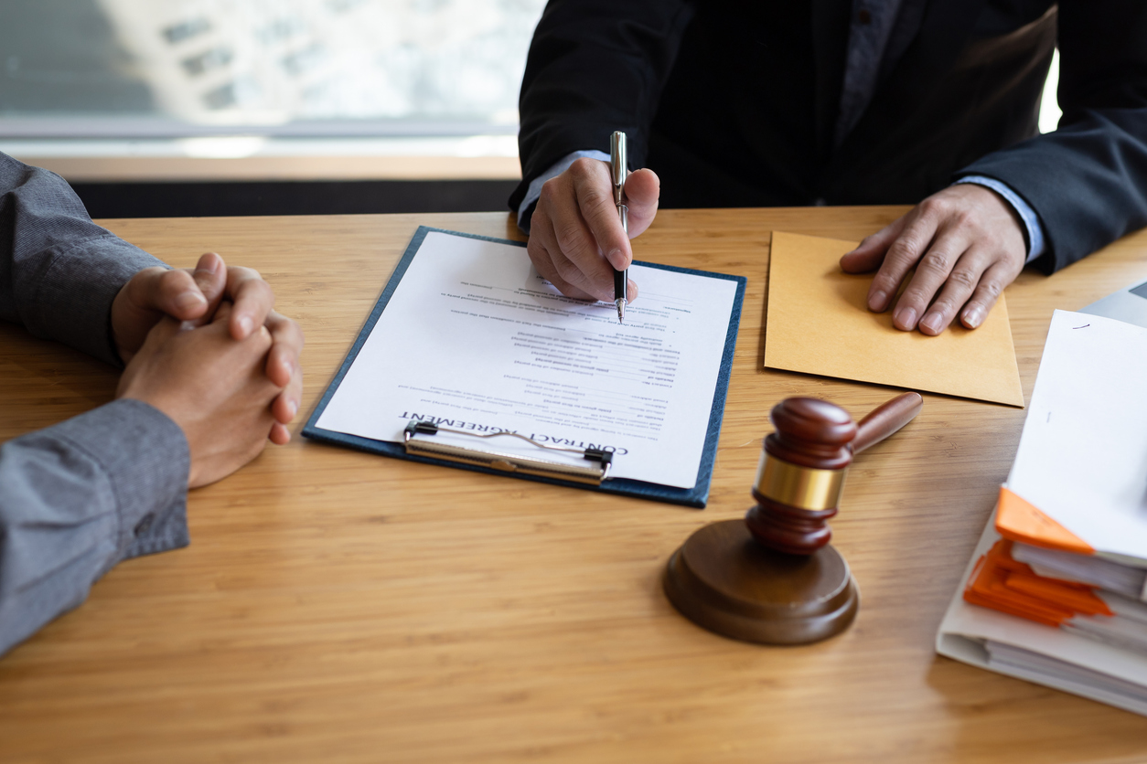 Businessman and lawyer discuss the contract document. Treaty of the law. Sign a contract business. Consultation of Businessman and lawyer or judge counselor, Law and Legal services concept.
