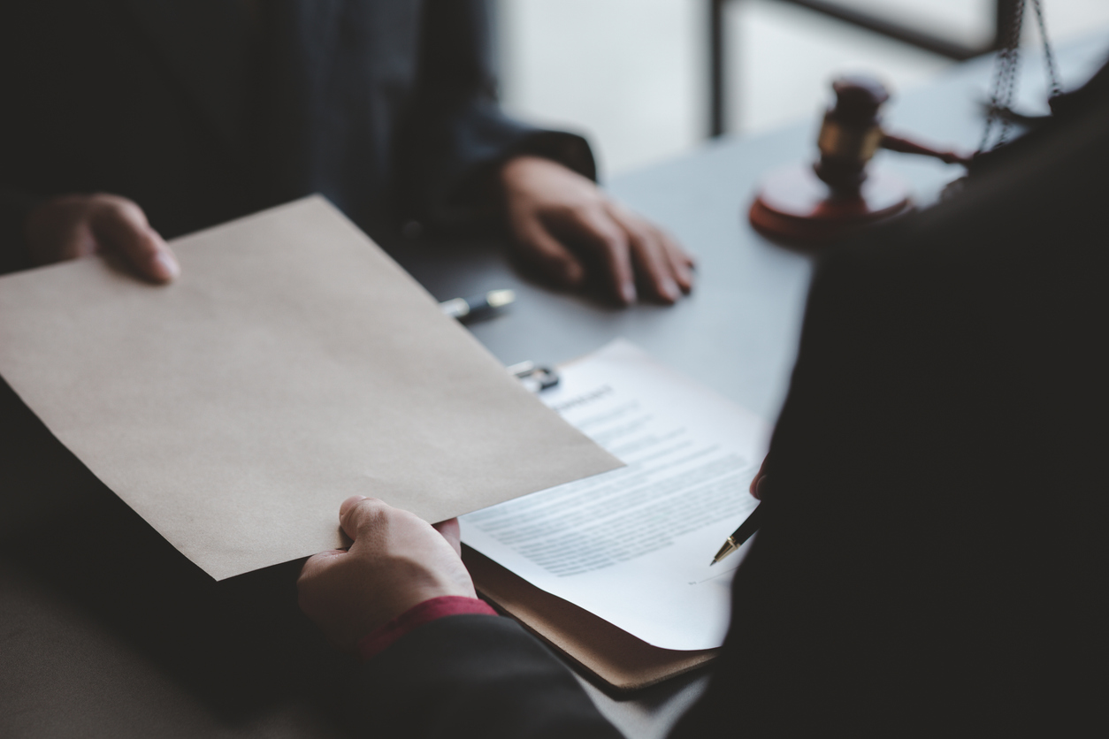 Lawyers hading documents.