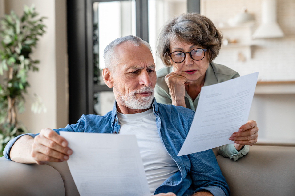 Senior old elderly spouses reading documents