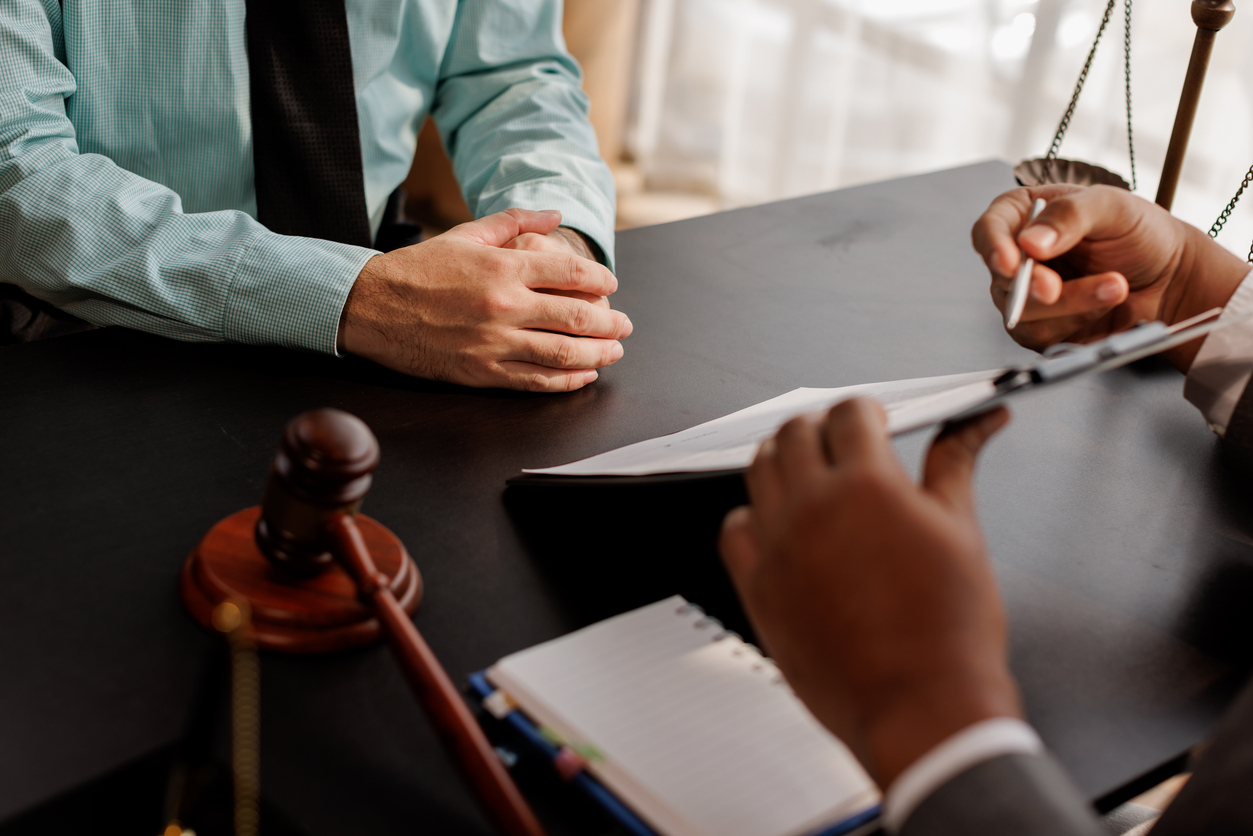law and justice. Lawyer Legal counsel presents to the client a signed contract with gavel and legal law. justice and lawyer Business partnership meeting concept.