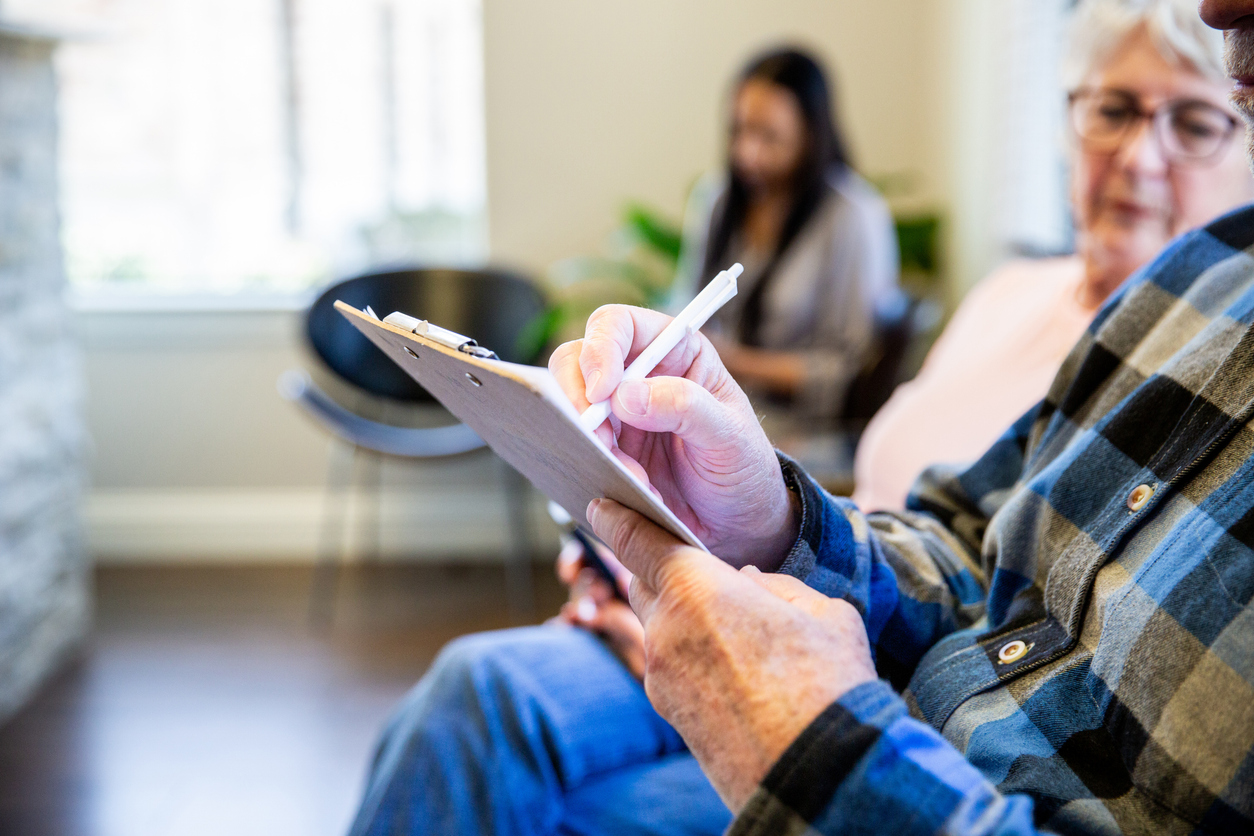 Patients and nurses in the waiting room interacting and checking in