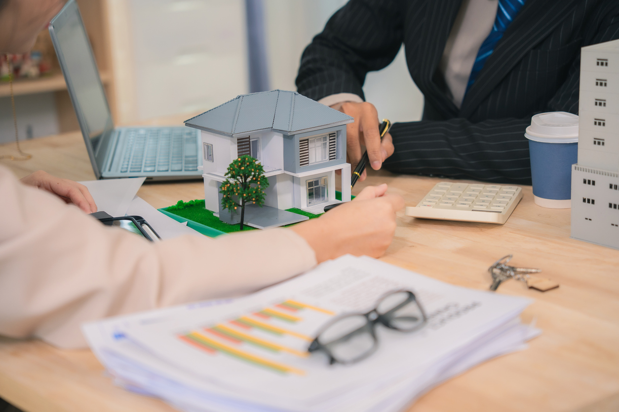 The business team discussed the real estate model in the meeting room, planning investment strategies for the real estate business. Experts analyzed the design of the real estate developer.