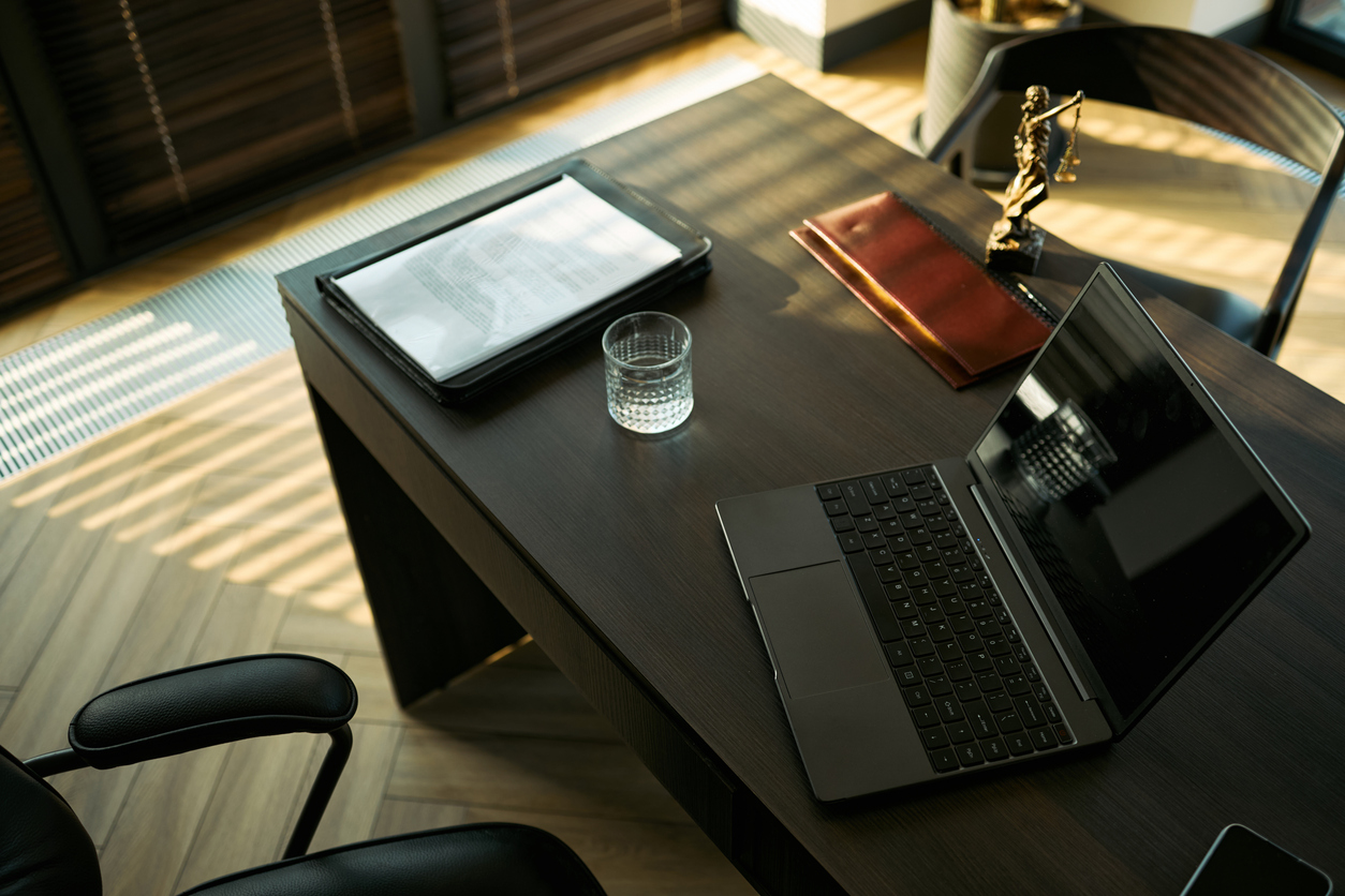 High angle view of lawyer desk displaying divorce documents, laptop, legal book, justice statue, symbolizing family law consultation and separation process. For legal service marketing