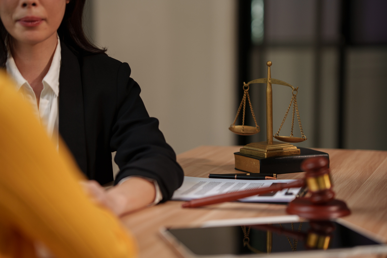 Professional Female Lawyer Comforting and Holding Client Hand with Empathy in Law Office