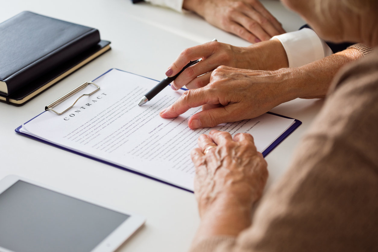 Lawyer explaining lease contract document to senior client