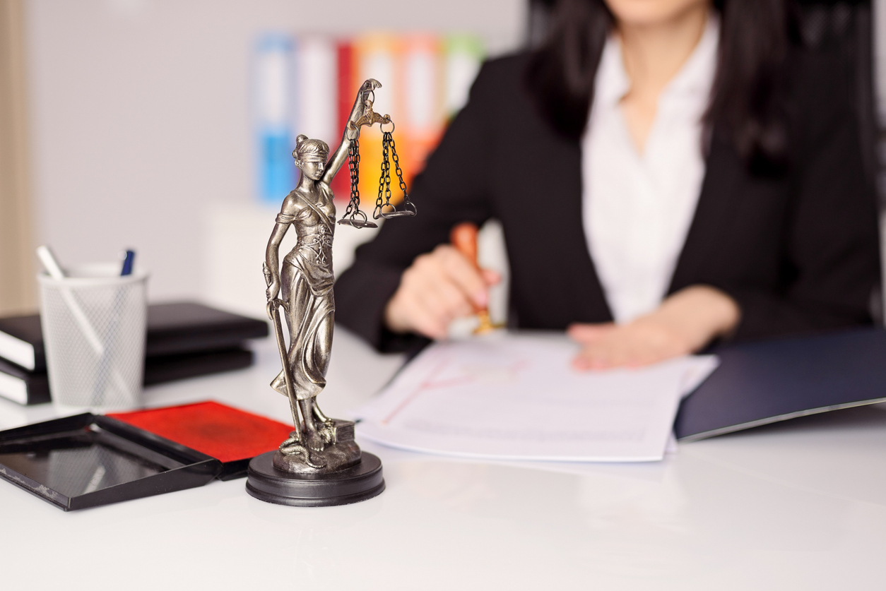 Statuette of Themis - the goddess of justice on lawyer's desk.